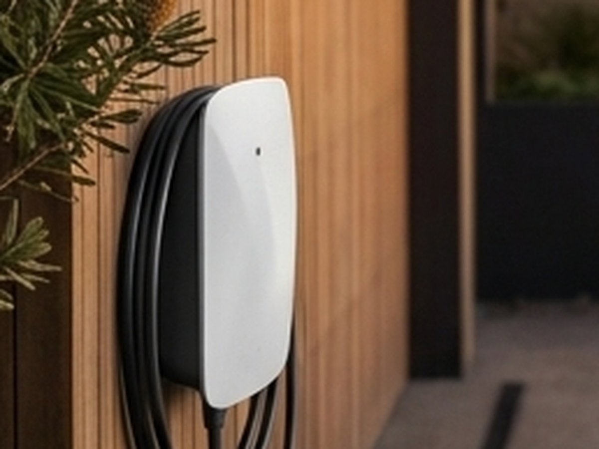 Wall-mounted home EV charger neatly installed on a timber wall