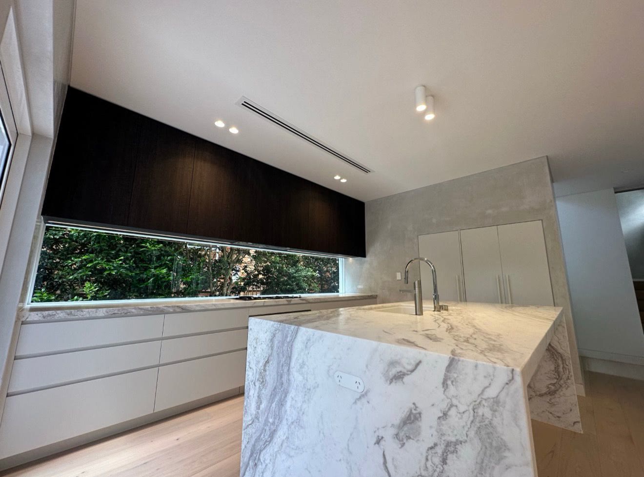 Modern kitchen with dark ceiling feature and downlights