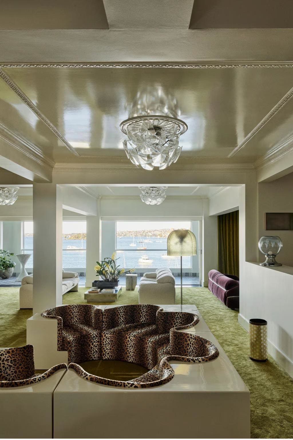 High-end Northern Beaches living room with feature lighting and water views, wired by Clear Logic Electrical