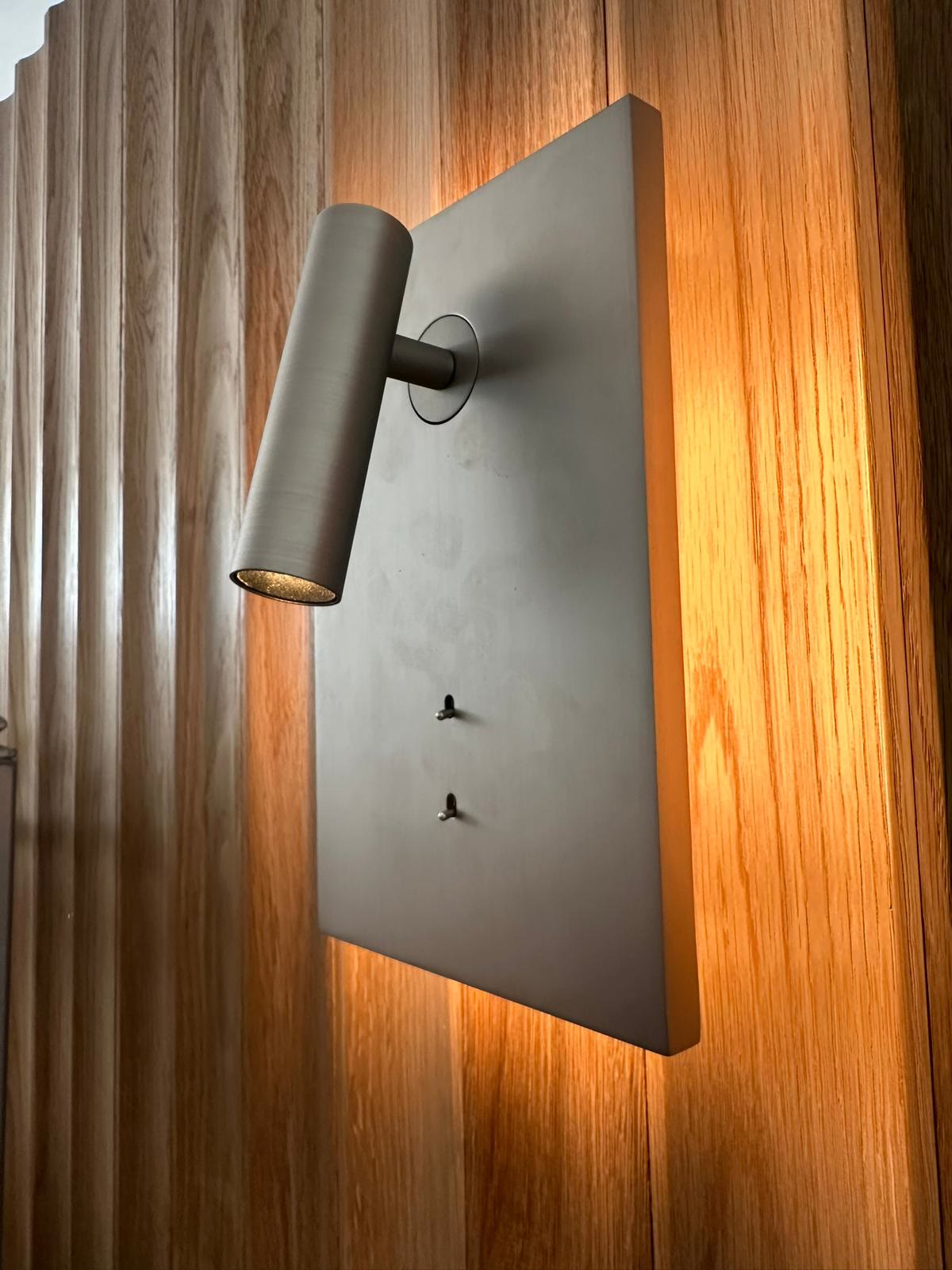 Adjustable reading light on a timber feature wall