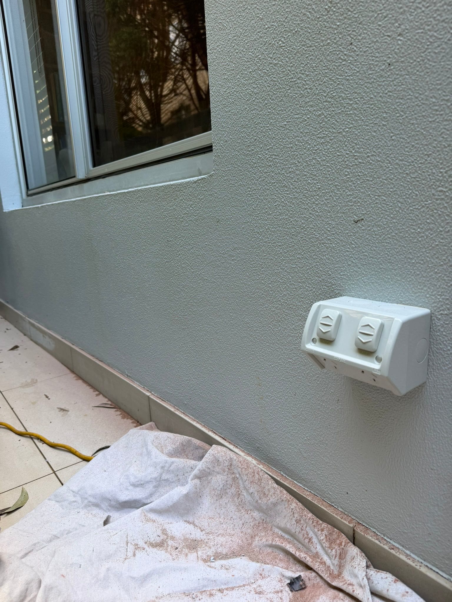Power point and switch being checked on a wall
