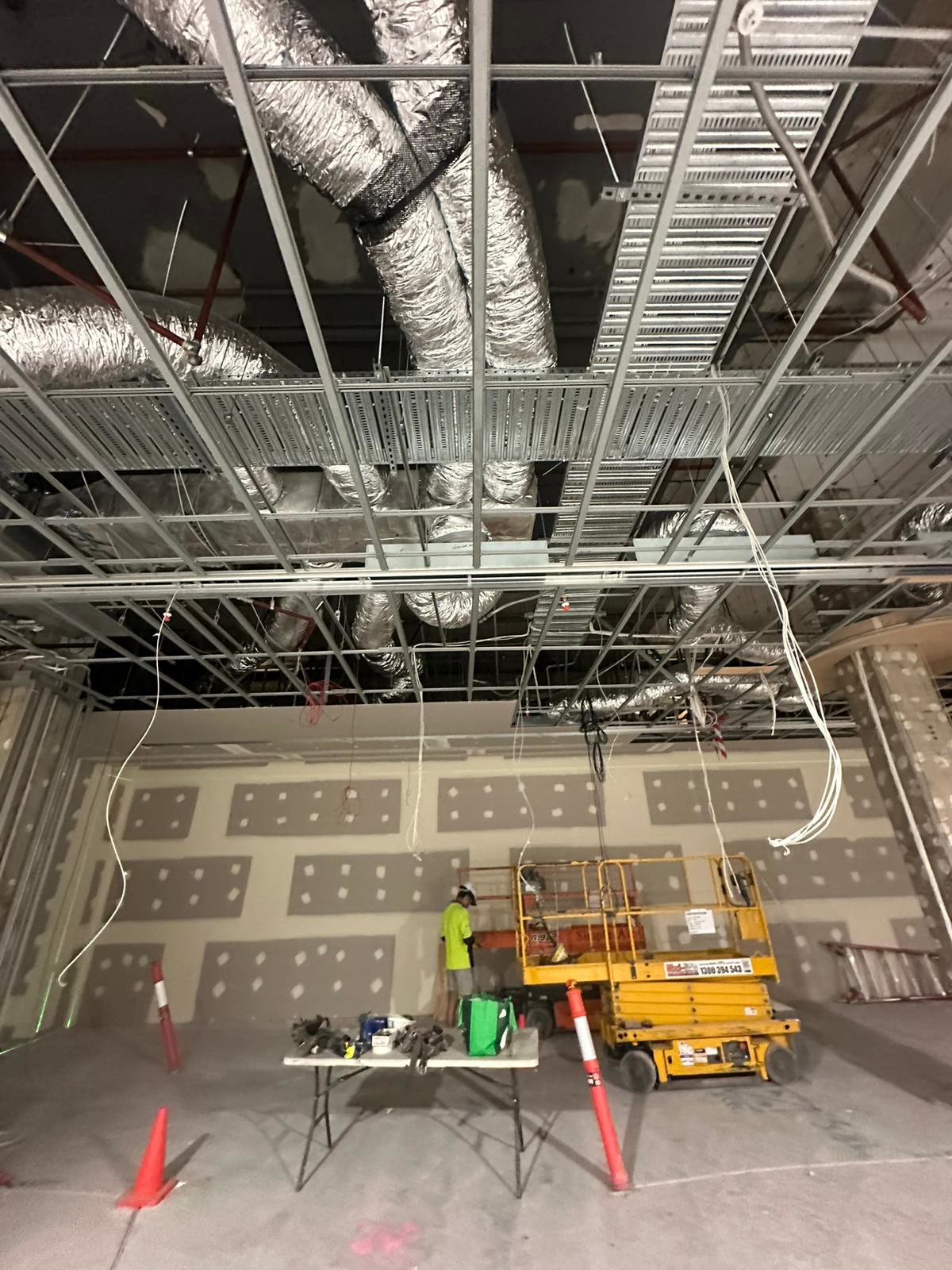Commercial ceiling rough-in with conduit and cabling on a fit-out