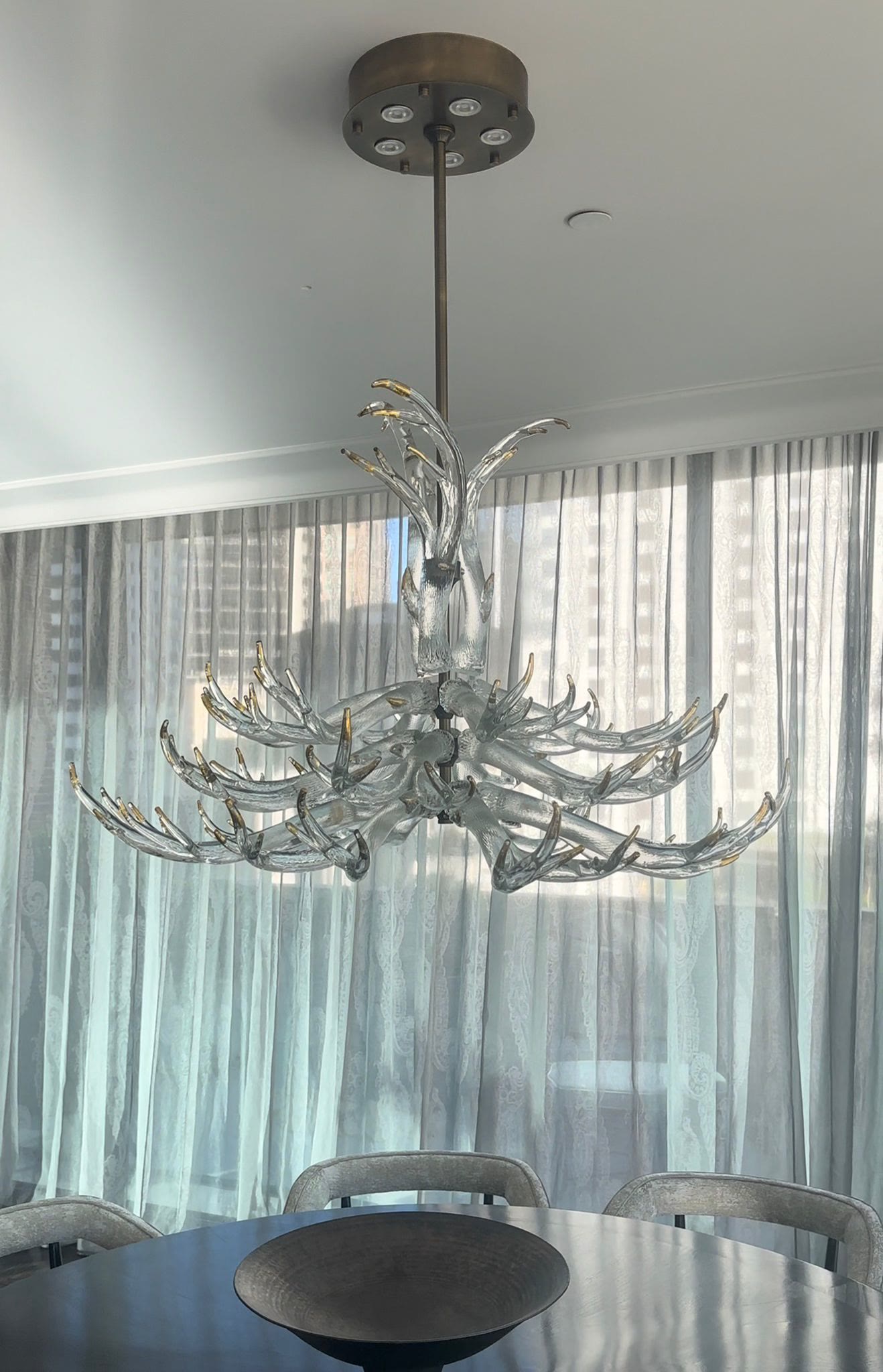 Antler chandelier over a living space with city views