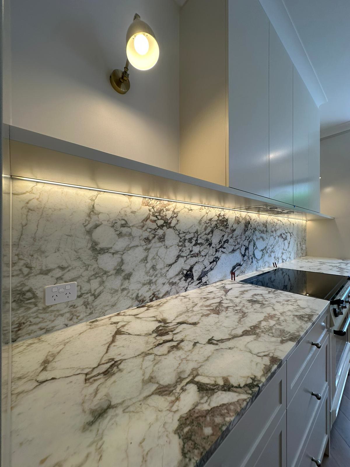 Kitchen with marble splashback and concealed LED lighting